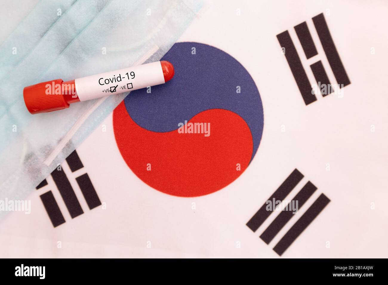 Concept of Novel Coronavirus spread from China to South Korea - 2019-nCoV or Covid-19 disease positive test on South korean flag showing with blood Stock Photo