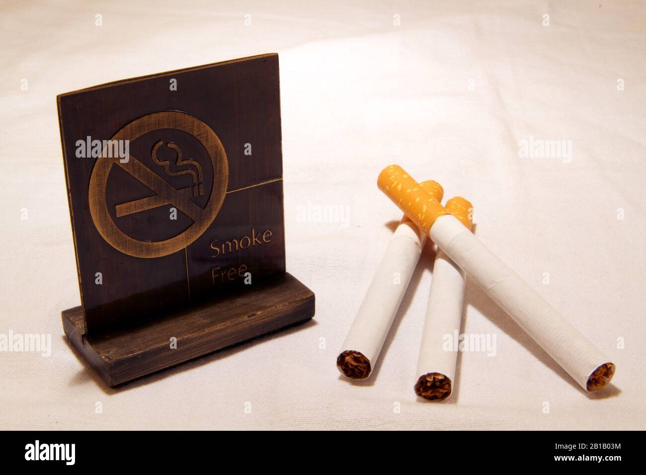 Dubai-No smoking metal tag with cigarettes on the table 18 Stock Photo