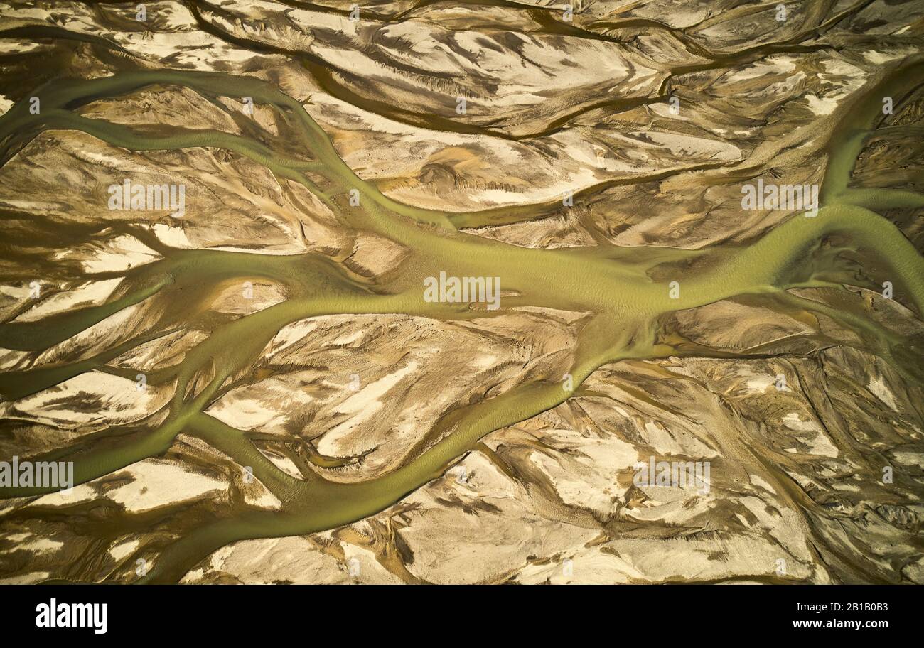 From above drone view of curvy stream with dirty water on rough ground in Icelandic highlands Stock Photo