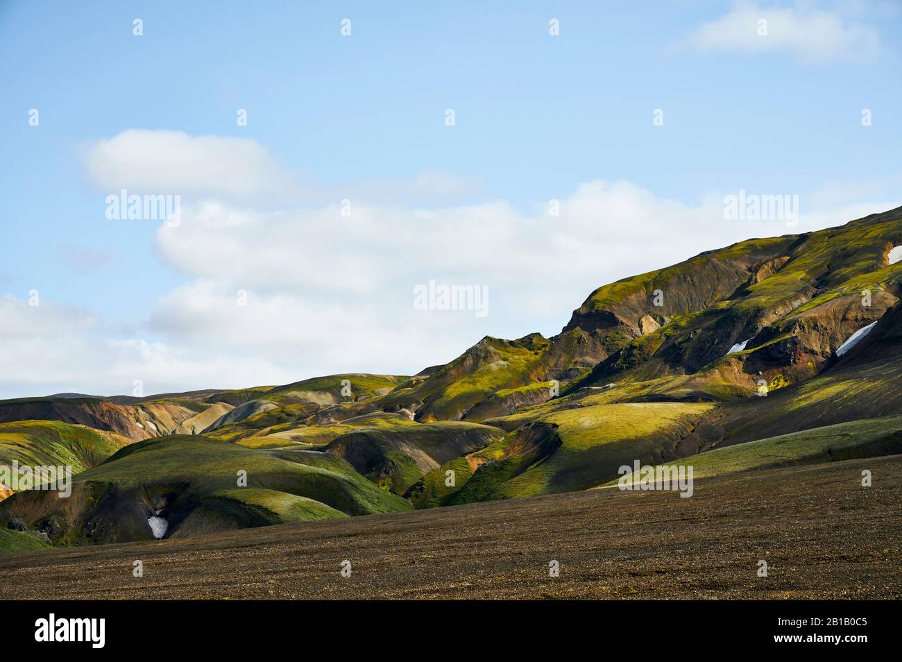 Sope Ridge Mountain ridge with grassy slope against gray overcast sky in Iceland ...