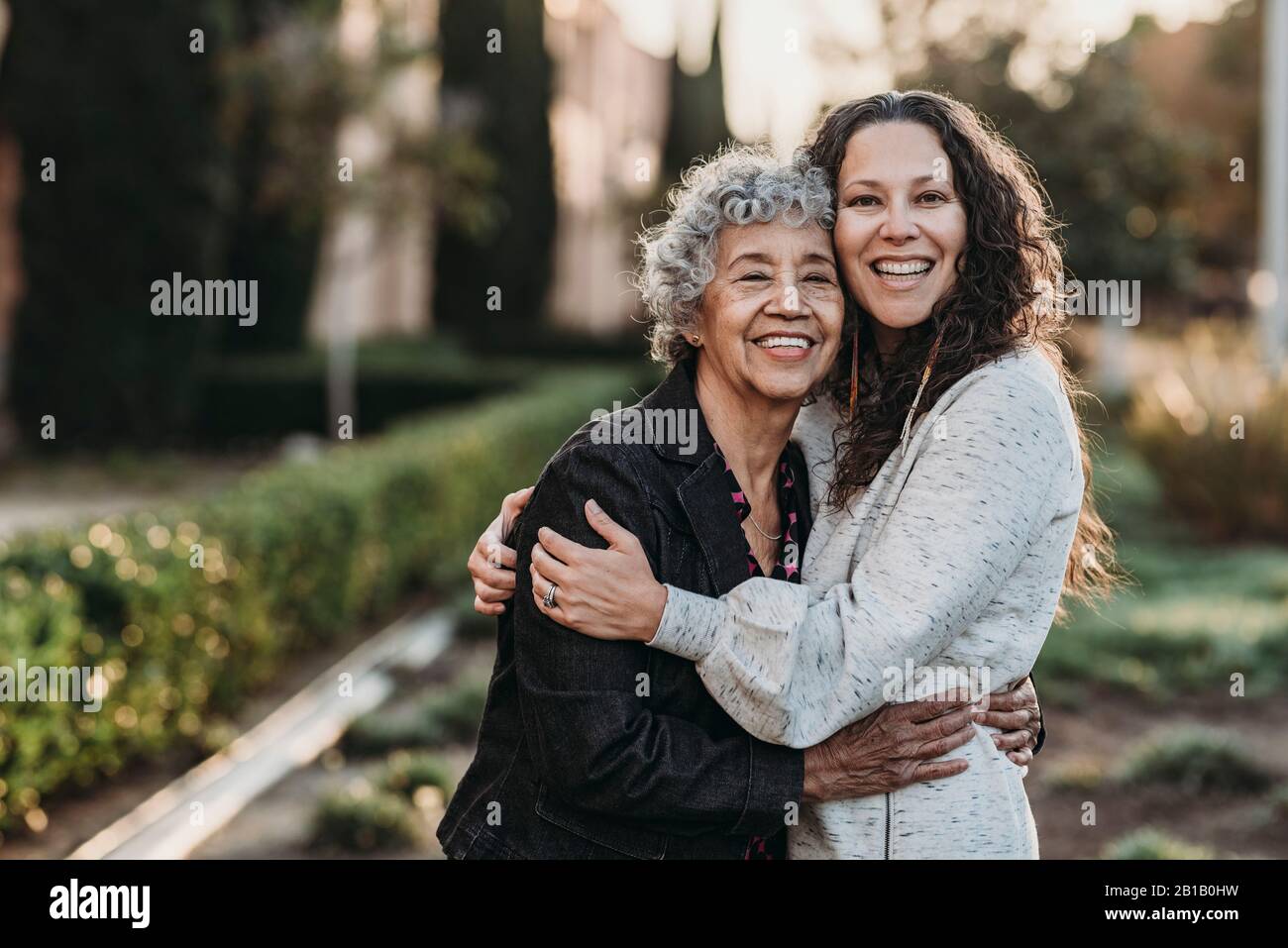 Portrait of active senior grandmother and adult daughter smiling Stock Photo