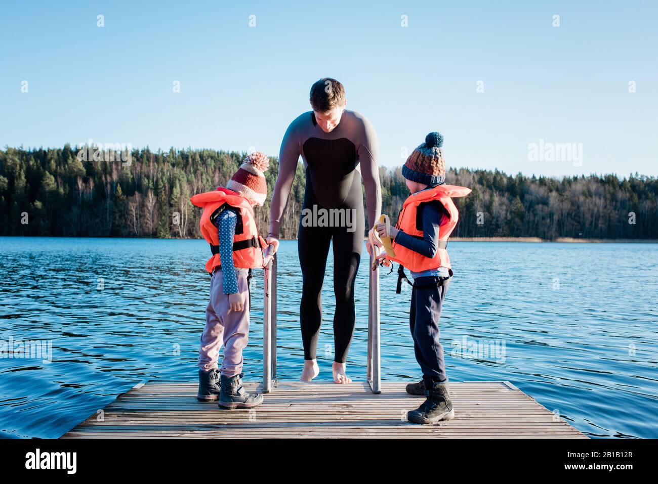 father and his children cold water swimming at the beach in Sweden
