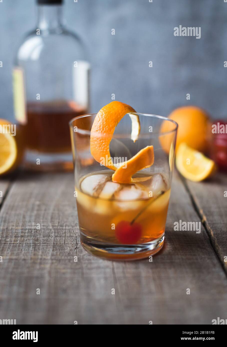 Close up of old fashioned cocktail with ingredients on wooden table. Stock Photo