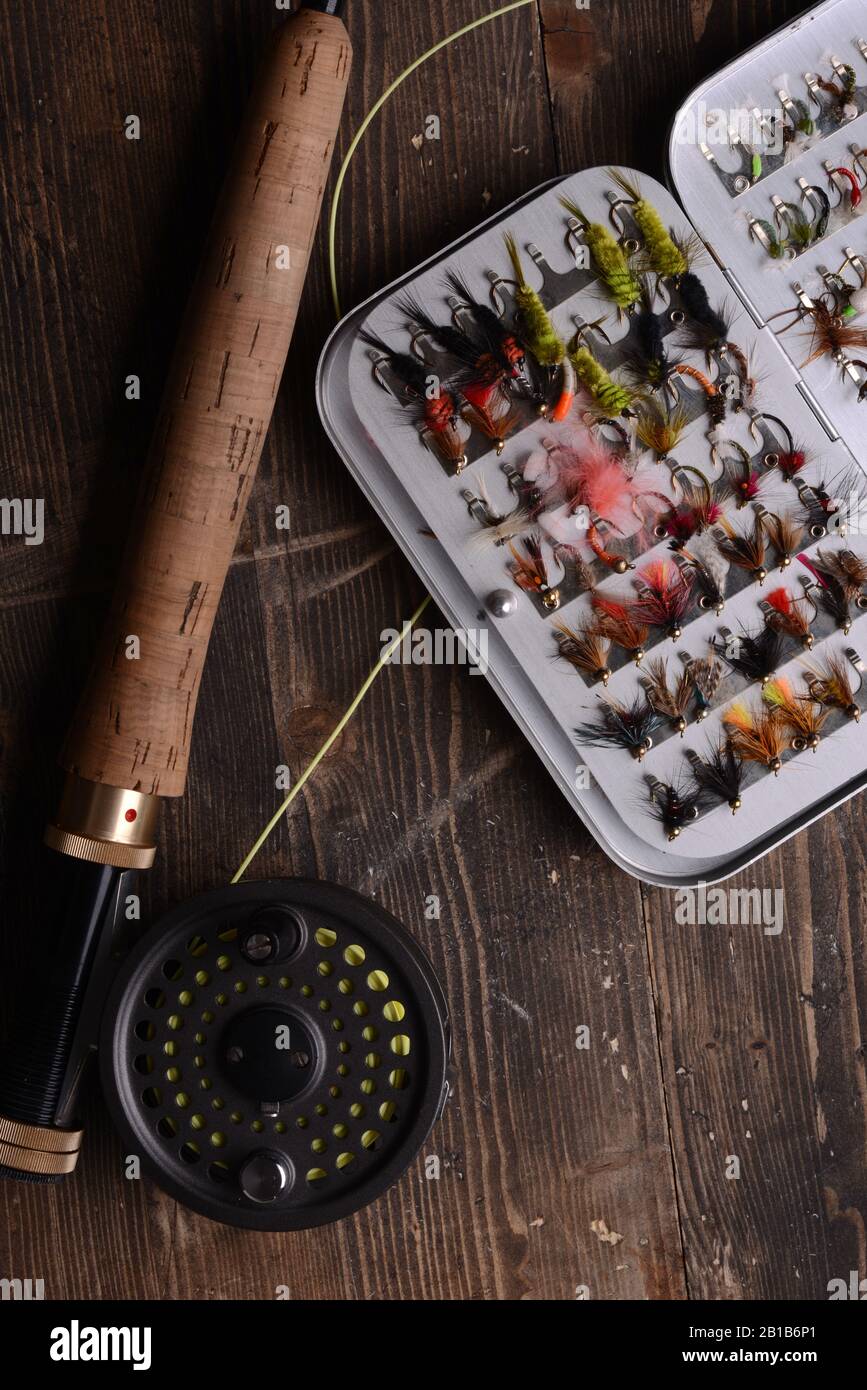 Fly Fishing reel and box of flies Stock Photo