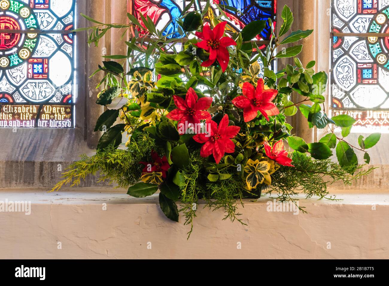 Christmas flower display at All Saints Church in East Budleigh. Stock Photo