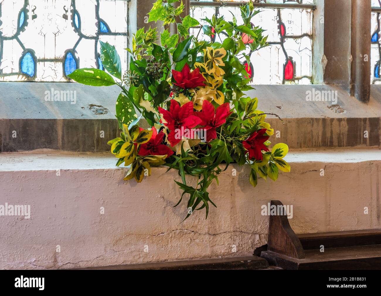 Christmas flower display at All Saints Church in East Budleigh. Stock Photo