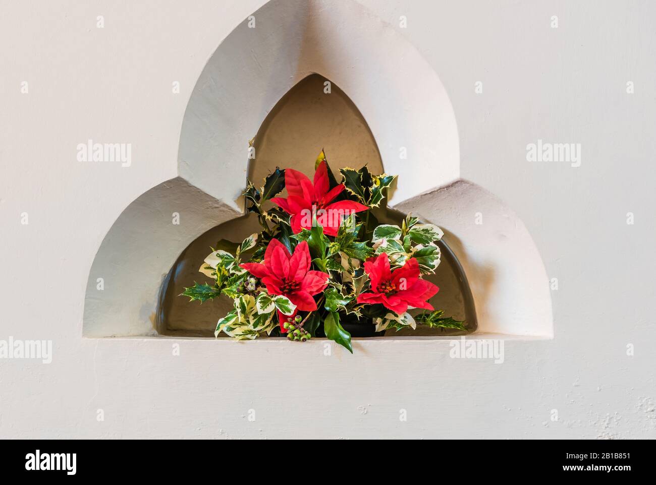 Christmas flower display at All Saints Church in East Budleigh. Stock Photo