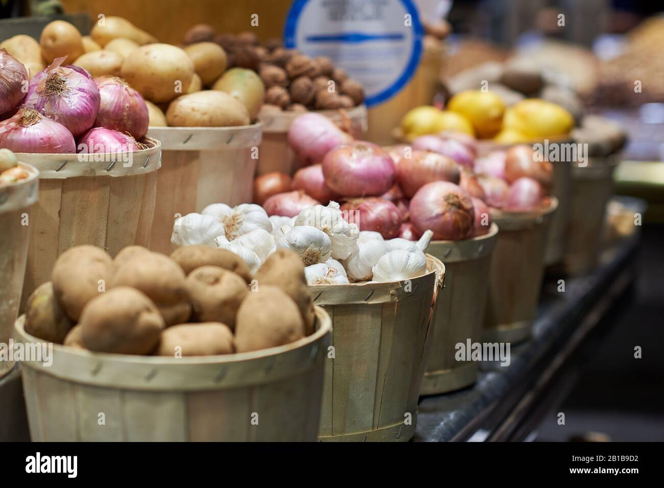 Onions and potatoes in wooden baskets Stock Photo Alamy