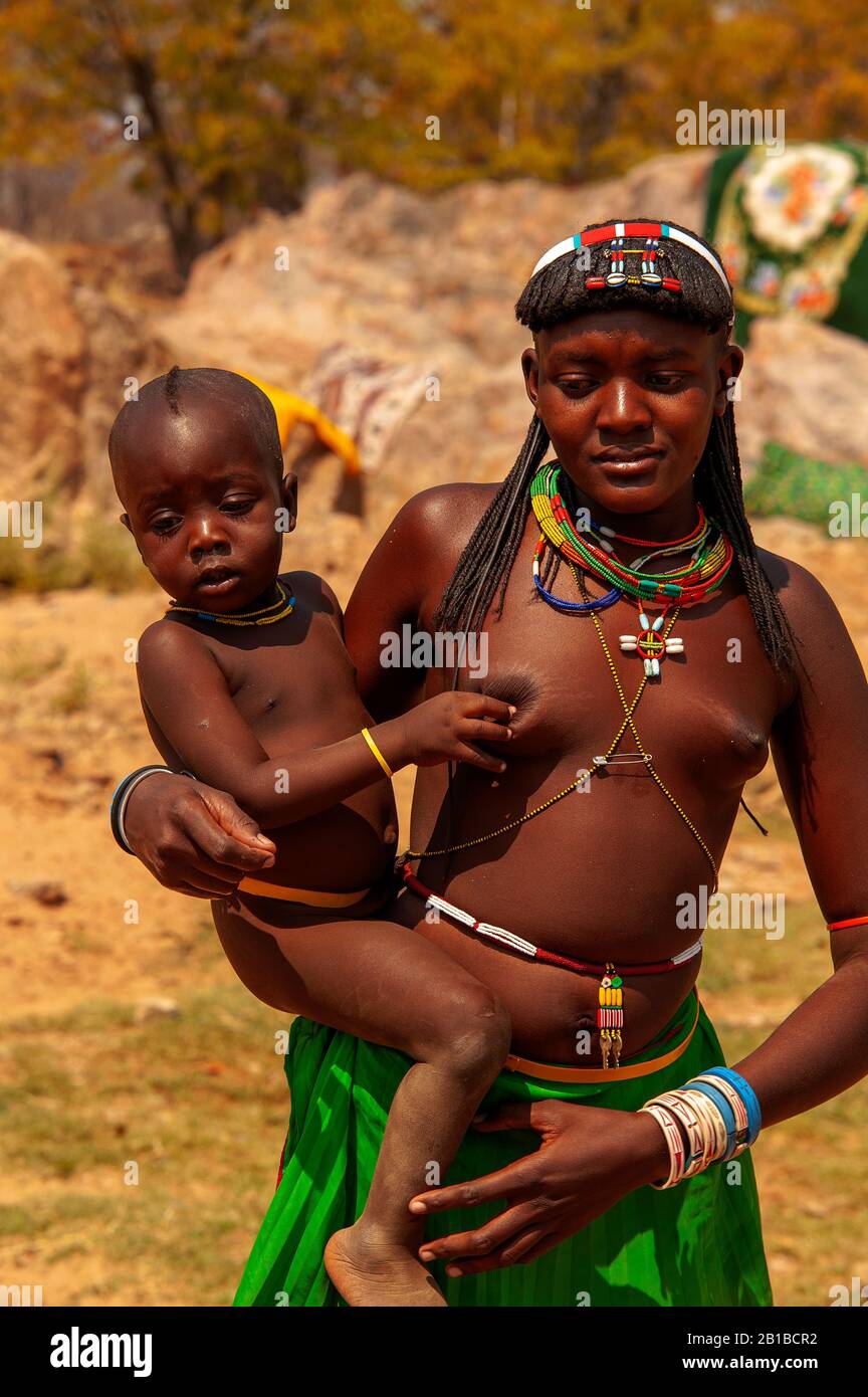 African woman with small kids right by the road D3701, Kunene Region, Northern Namibia Stock Photo