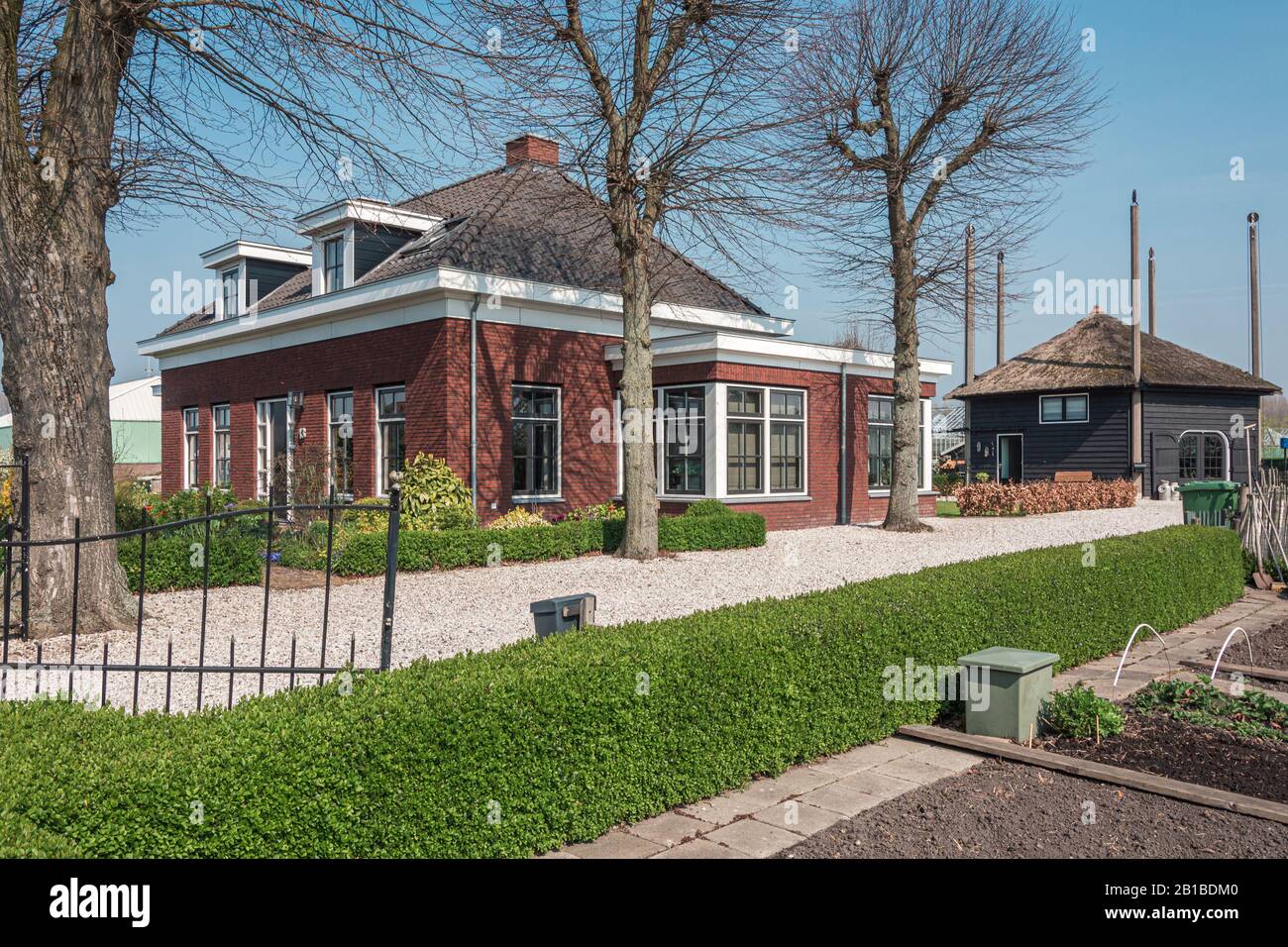 Nootdorp, The Netherlands, April 7, 2019:  Beautiful bungalow  with kitchen garden and a hay loft converted into a home situated between huge greenhou Stock Photo