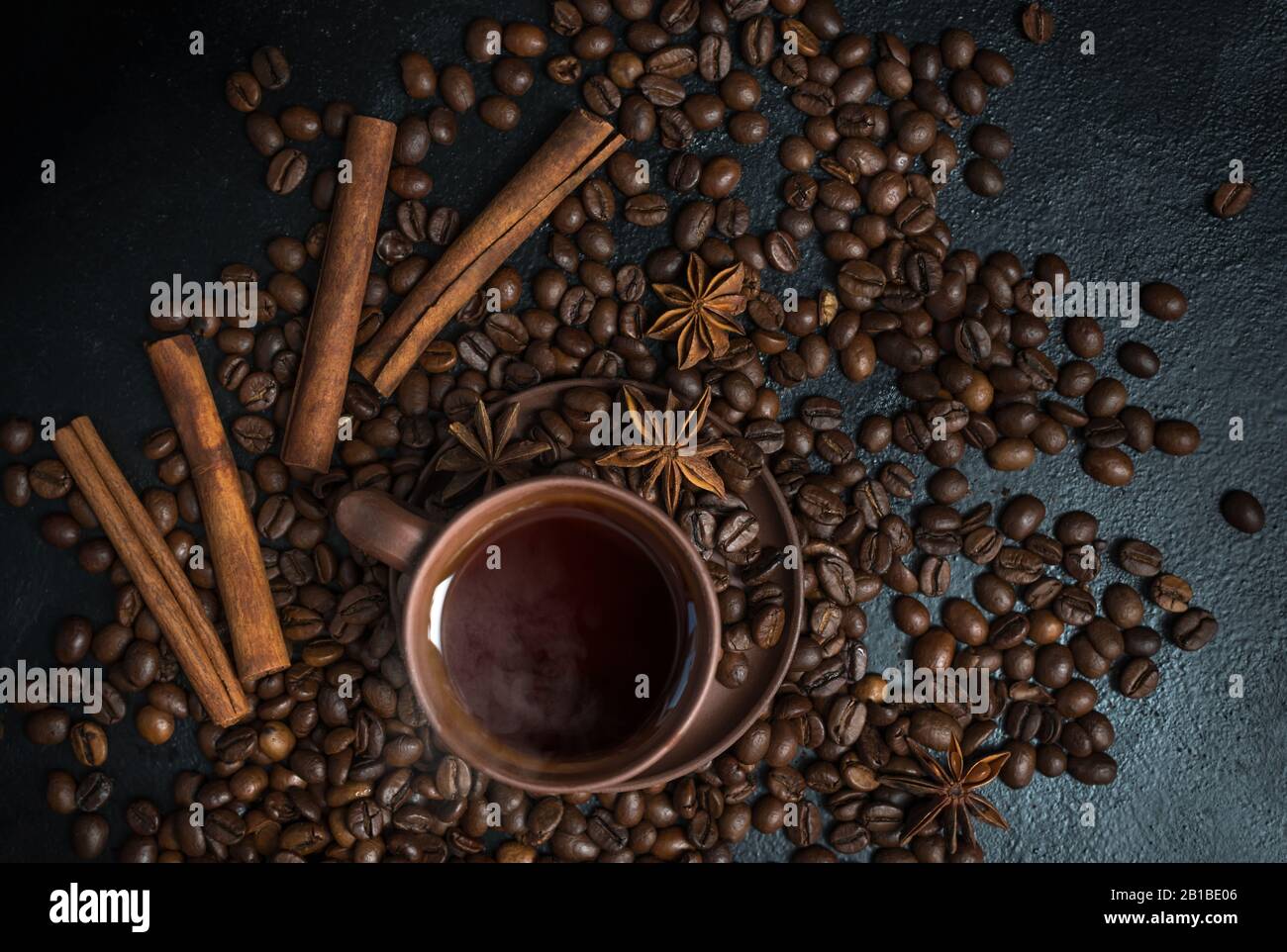 Coffee. Roasted coffee beans background. Coffee cup and beans on old kitchen table. Top view with copyspace for your text. Кофе. Кофейные зерна. Stock Photo