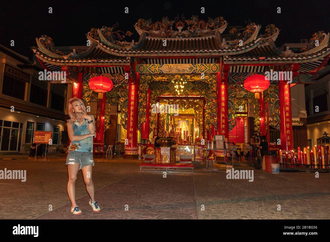 A lady dress stylishly standing in front of a shrine at Chainatown Bangkok. Stock Photo