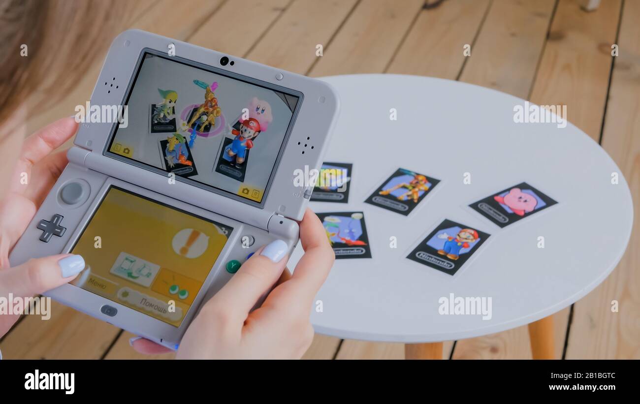 Woman gamer using game console Nintendo 3ds with AR app Stock Photo - Alamy