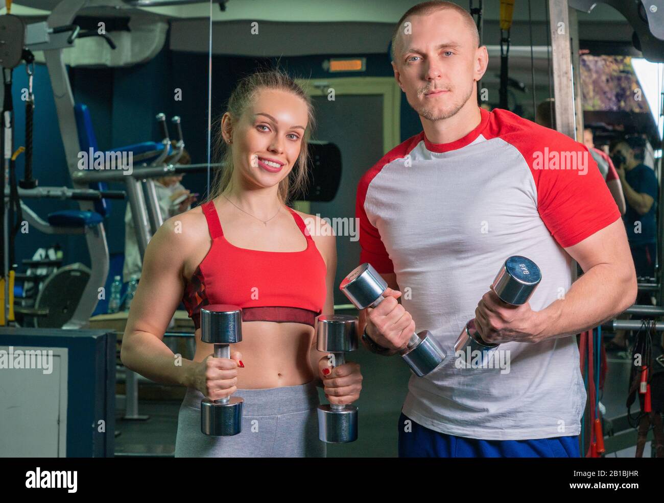 personal trainer man working with young woman in modern gym Stock Photo ...