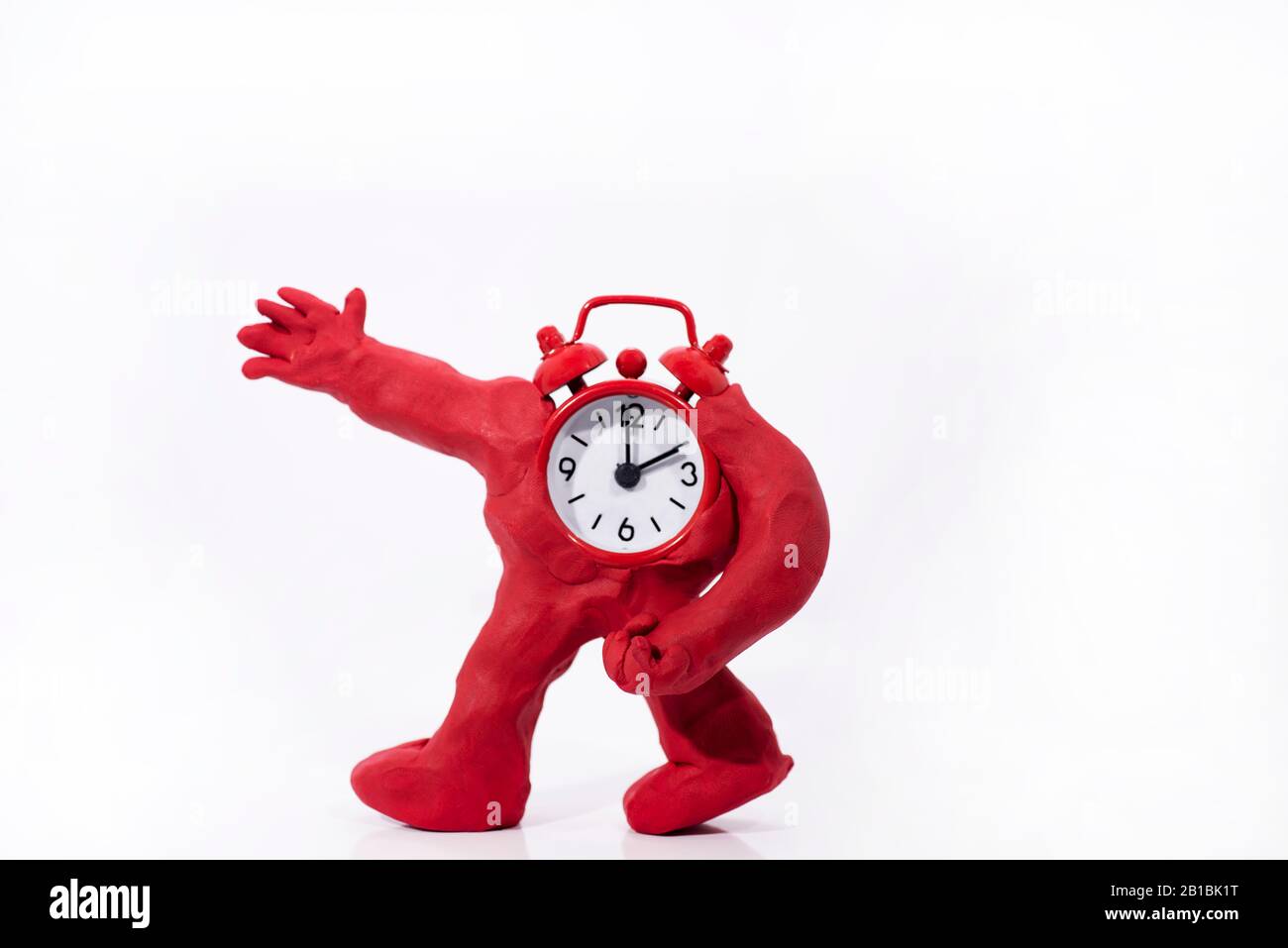 Funny ClockMan made from Play Clay. Isolated on white background Stock
