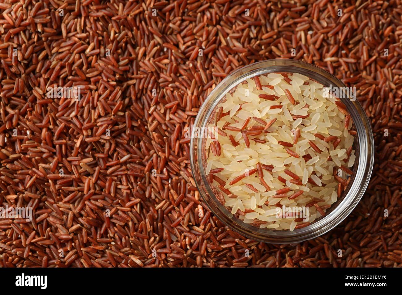 Rice background and glass bowl, close up and top view Stock Photo - Alamy