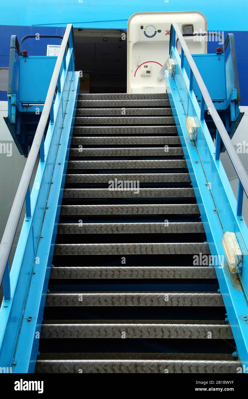 Schiphol, Amsterdam, the Netherlands - June 21, 2014: Open door end blue mobile aircraft stairway of Royal Dutch Airlines KLM. Stock Photo