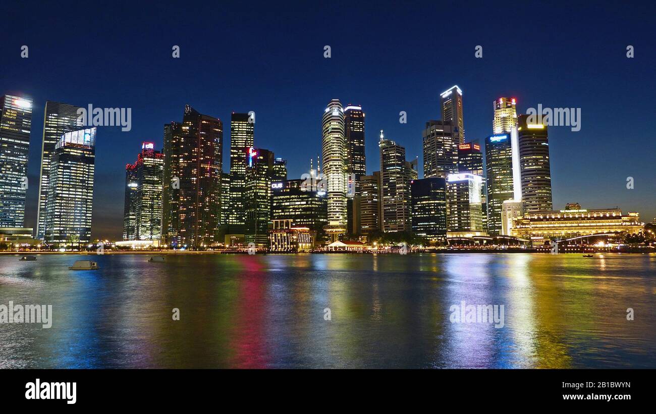 City skyline at night with reflections in river Stock Photo - Alamy