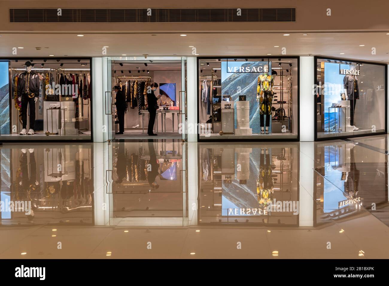 A masked shop keepers of the luxury brand Versace inside Harbour City Mall  - one of the Hong Kong's premier shopping destination usually full of  tourists and shoppers.The deadly coronavirus (known as