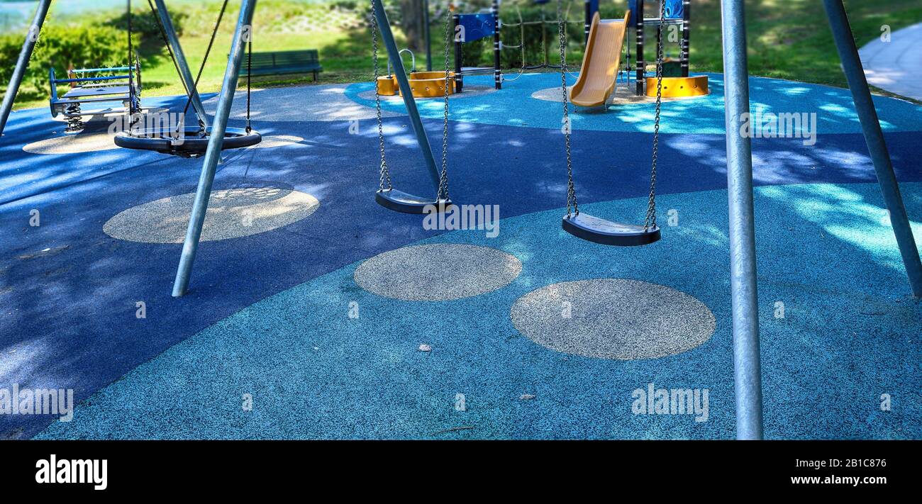 swing in the playground. chain swings on modern kids playground Stock Photo