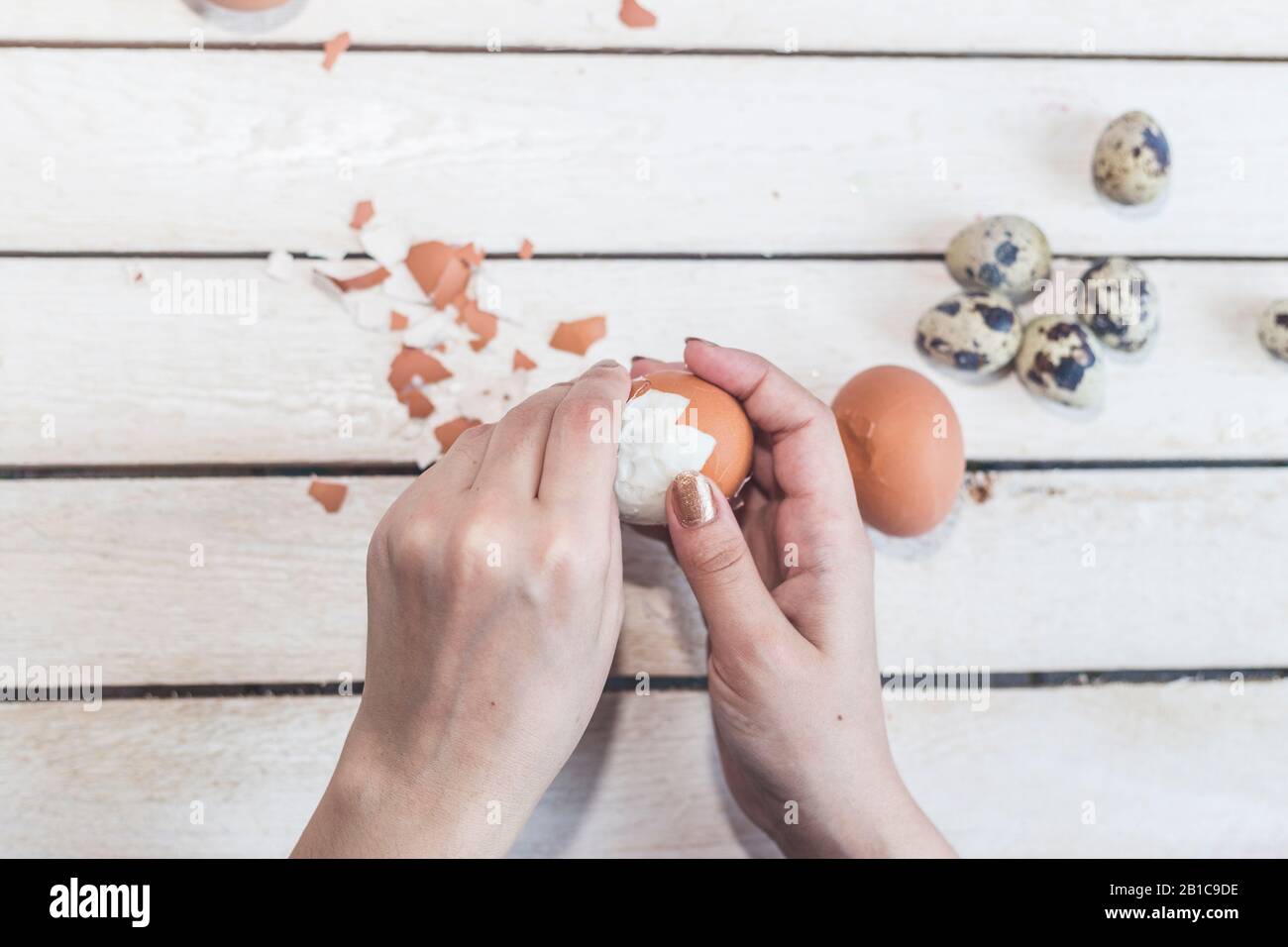 Hands of an unrecognizable woman cleaning boiled eggs. Egg cleaning