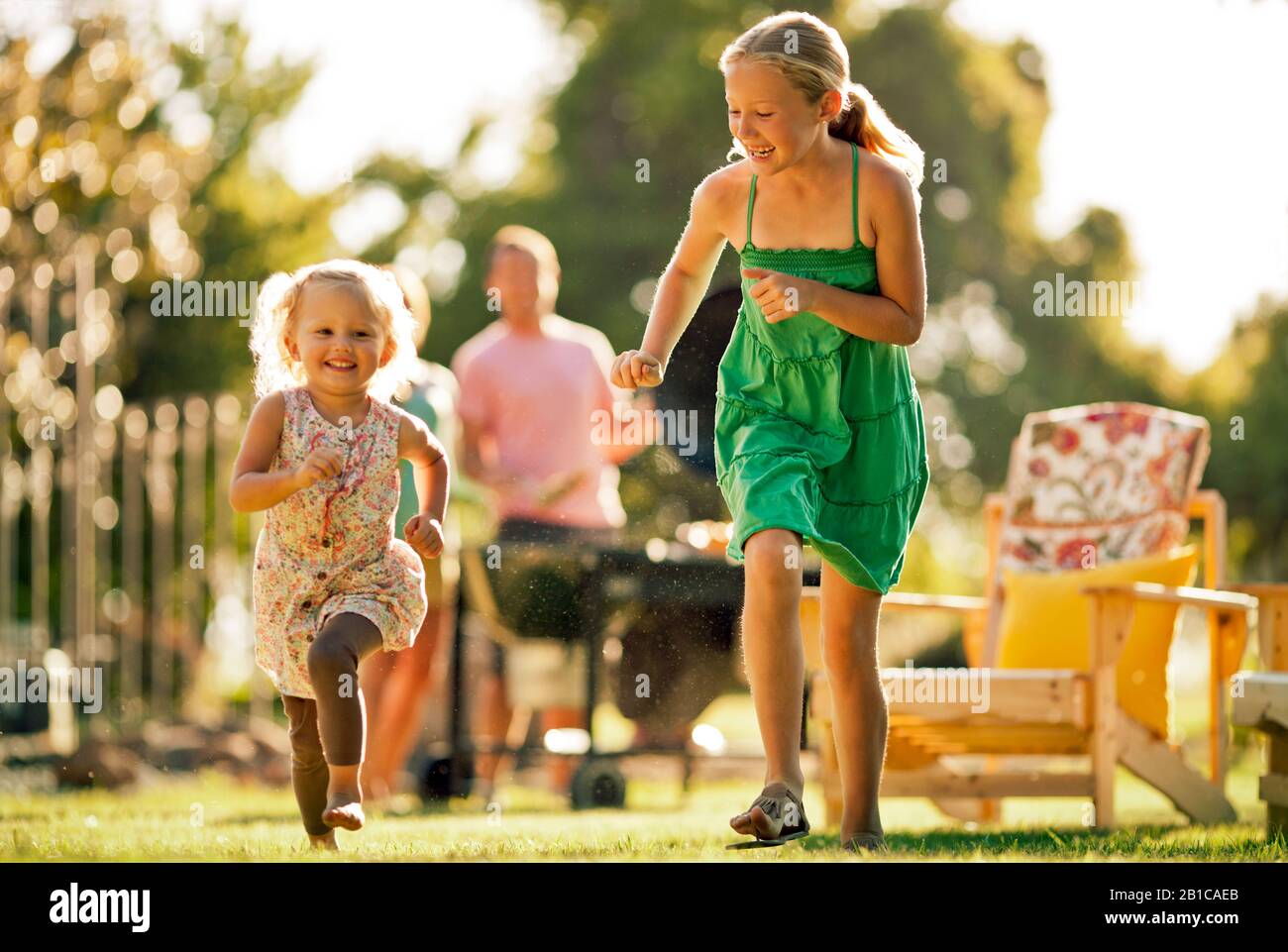 Happy siblings playing in their backyard. Stock Photo