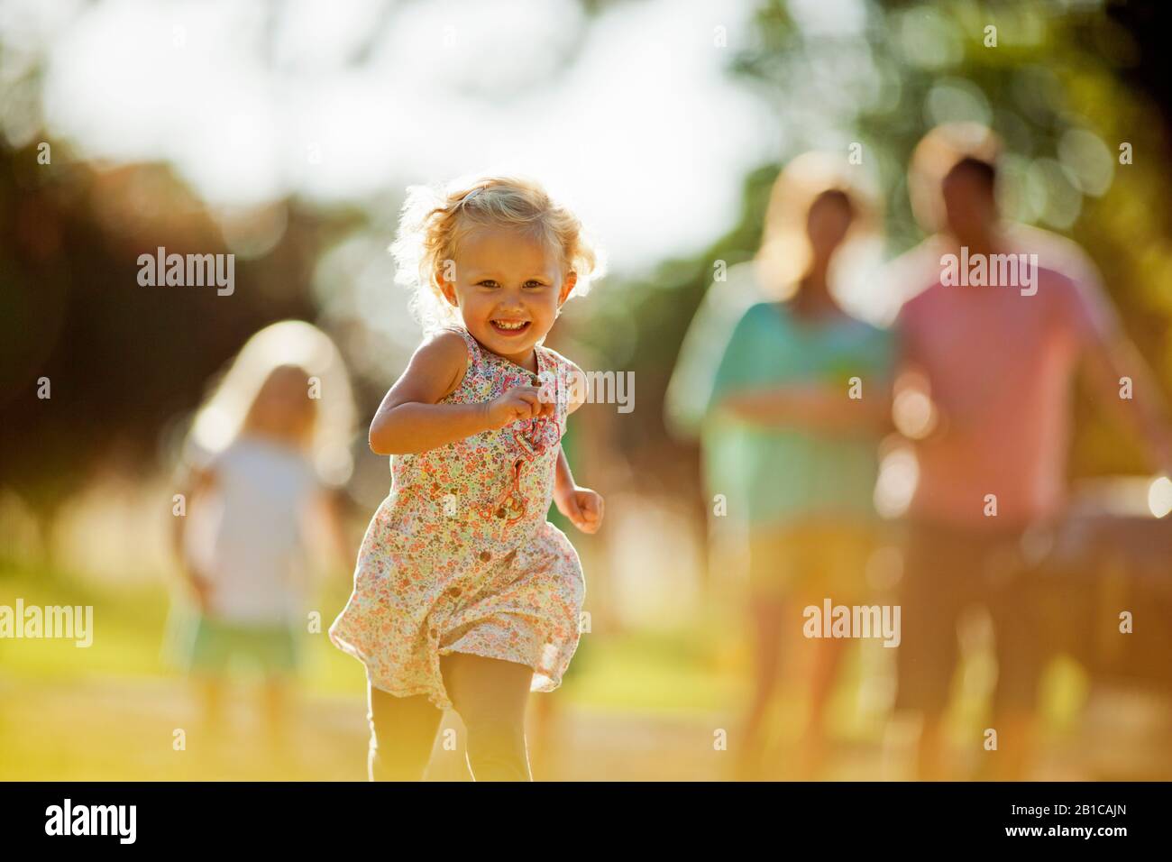 Happy siblings playing in their backyard. Stock Photo
