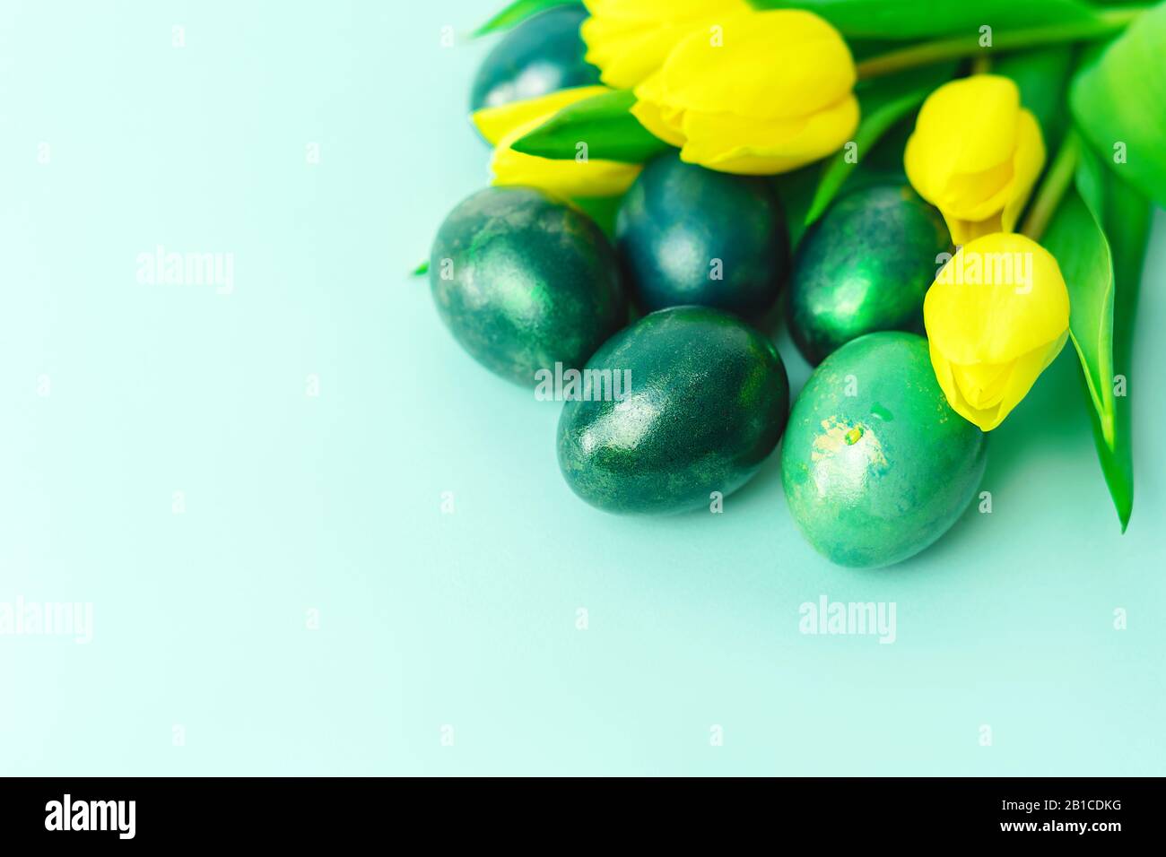Beautiful spring concept with Easter eggs and yellow tulips on ...