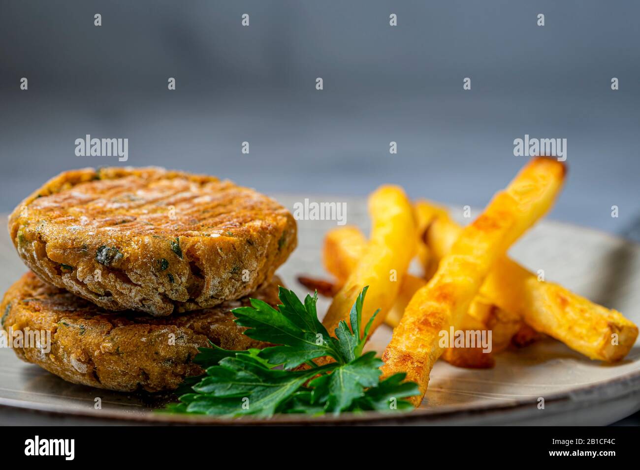 Vegan chickpea patties with oven fries. Stock Photo