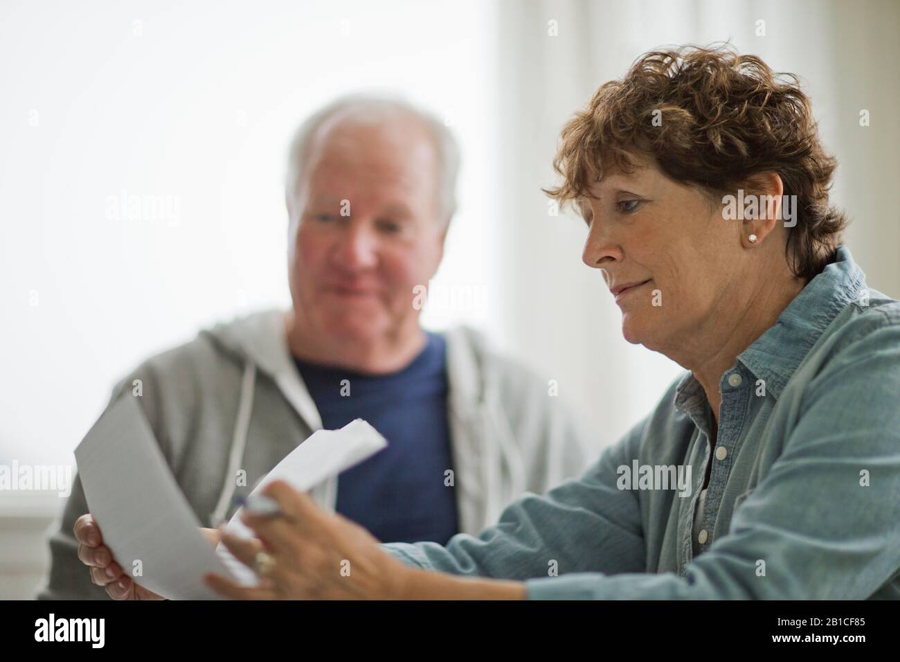 Senior couple looking over important documents. Stock Photo