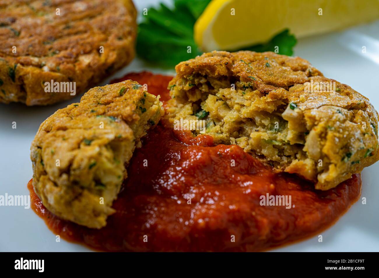 Vegan chickpea patties with tomato sauce. Stock Photo