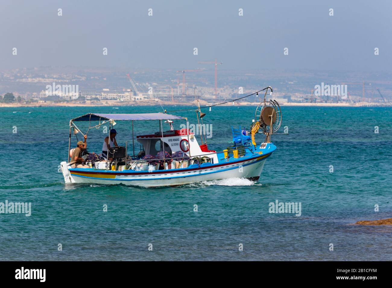 Traditional Cypriot fishing boat heading out to sea from Potamos Creek, Cyprus. 2019 Stock Photo