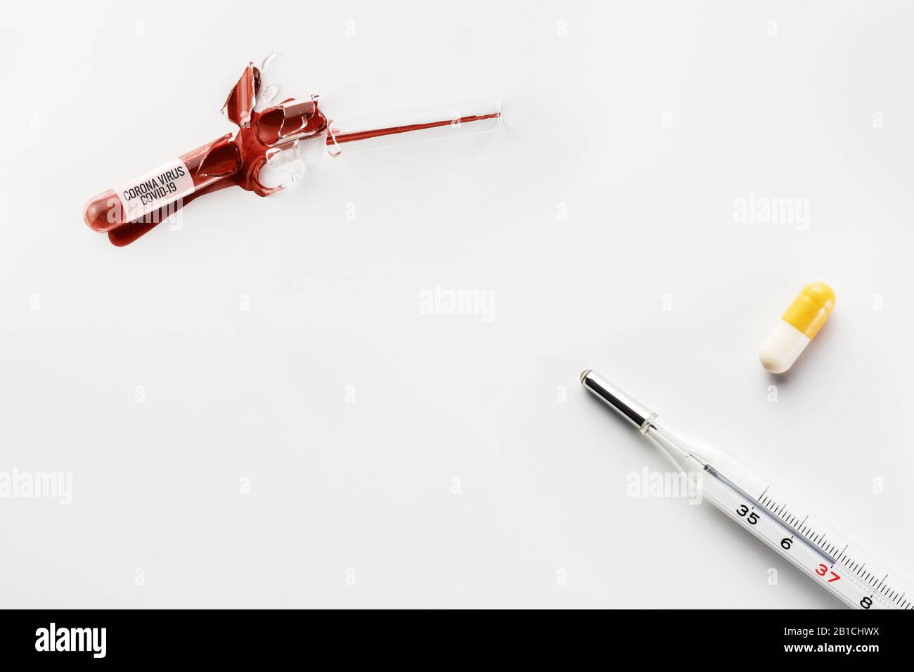 Corona virus infected blood spilled from broken glass test tube, thermometer and pill on white. Corona virus, COVID-19, pandemic and medicine concepts Stock Photo