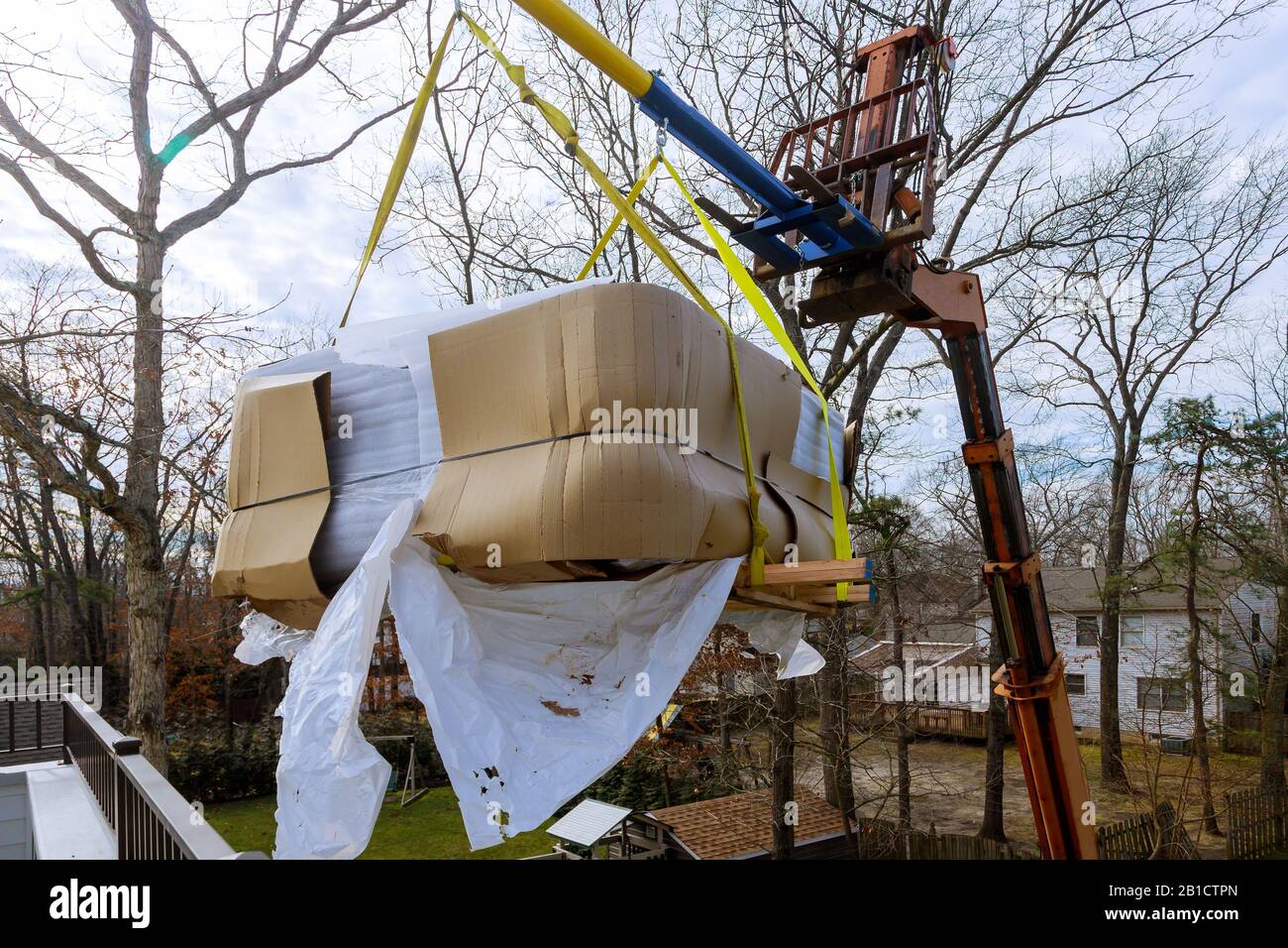 Scale weight above blue sky industrial crane moving with bathtub jacuzi Stock Photo