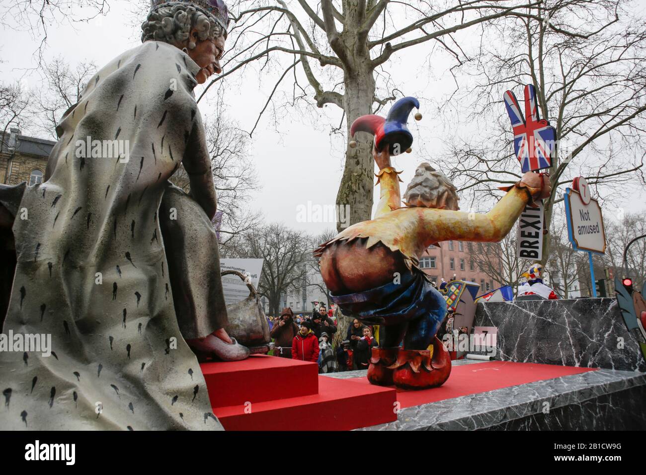 Mainz, Germany. 24th February 2020. British Prime Minister Boris Johnson and Queen Elizabeth II are depicted on a float in the Mainz Rose Monday parade. Boris Johnson is wearing a jester's dress and holds a Brexit sign, while showing his naked bottom to the Queen. Around half a million people lined the streets of Mainz for the traditional Rose Monday Carnival Parade. The 9 km long parade with over 9,000 participants is one of the three large Rose Monday Parades in Germany. Stock Photo
