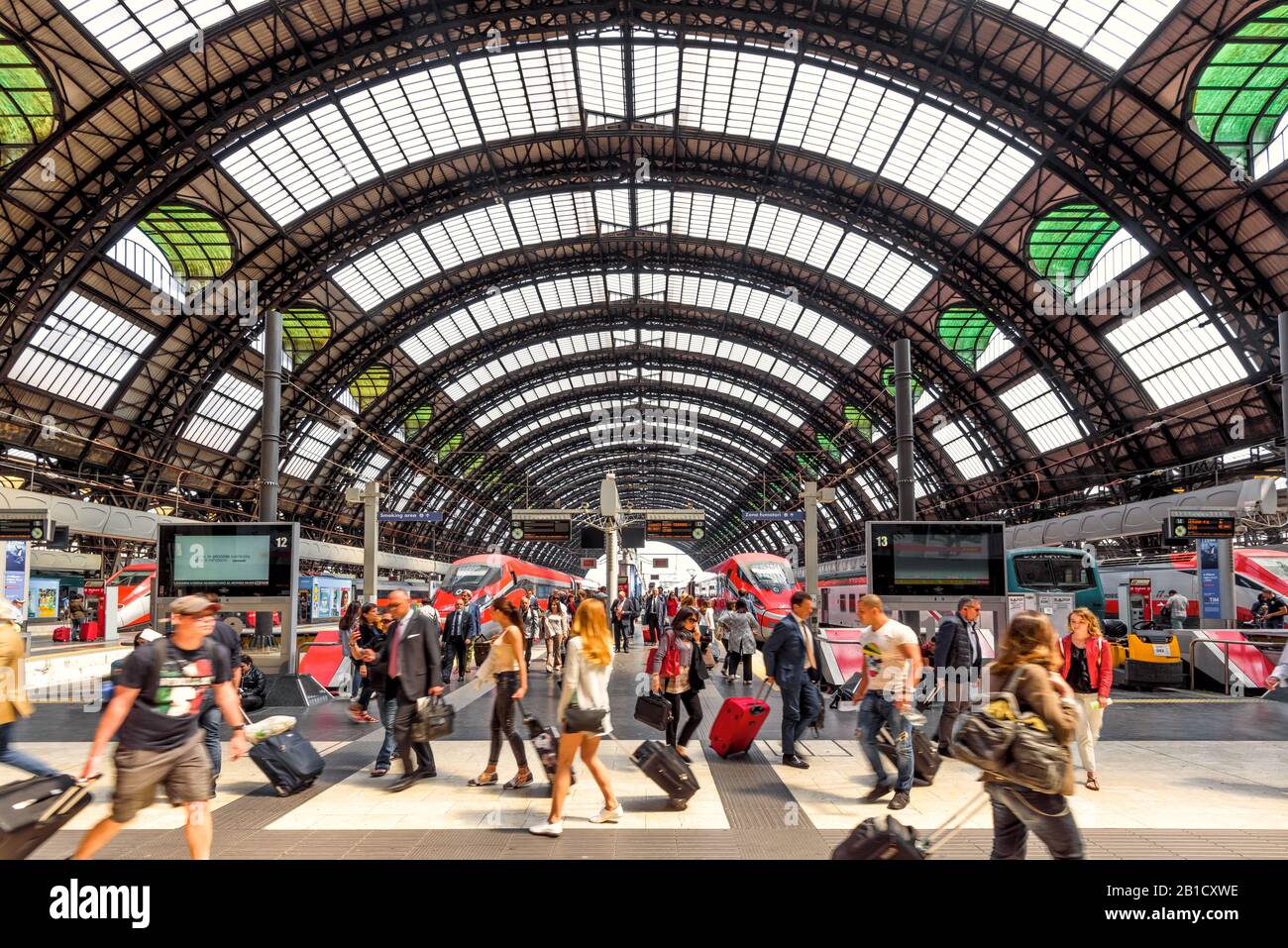 Milan, Italy - May 17, 2017: People visit the Milan Central Station with high-speed trains. Crowds of tourists at the Milan railway station. Concept o Stock Photo