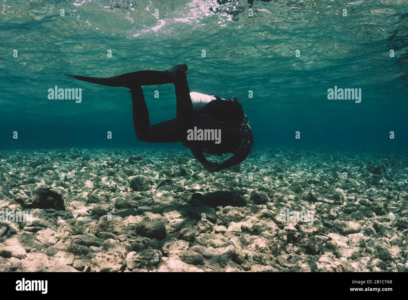 GUE diver in shallow waters Stock Photo