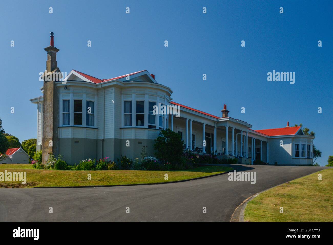 Mid 1900's architecture of Bushy Park, an estate in the North Island of New Zealand. An elaborate weatherboard structure with corrugated tin roofing. Stock Photo