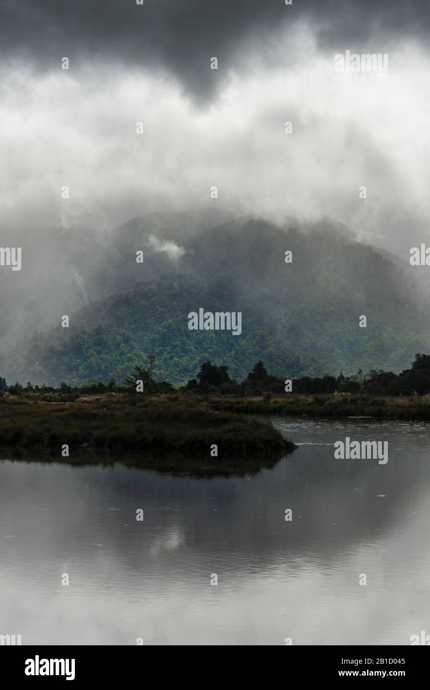 Moody overcast lighting at the Collingwood Inlet, in the Marlborough region of New Zealand's South Island. Stock Photo