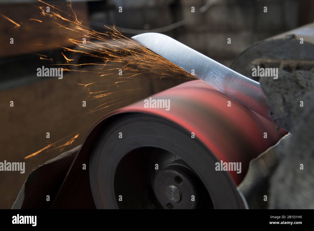 Polishing knife blade on sander Stock Photo Alamy
