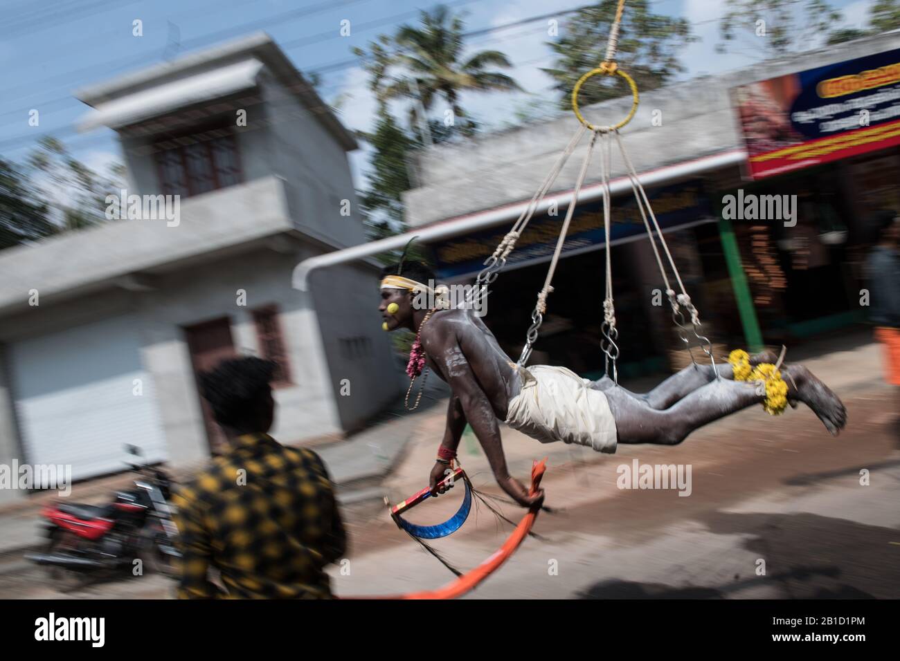 Devotee hanging by hook piercings as a ritualistic act of devotion