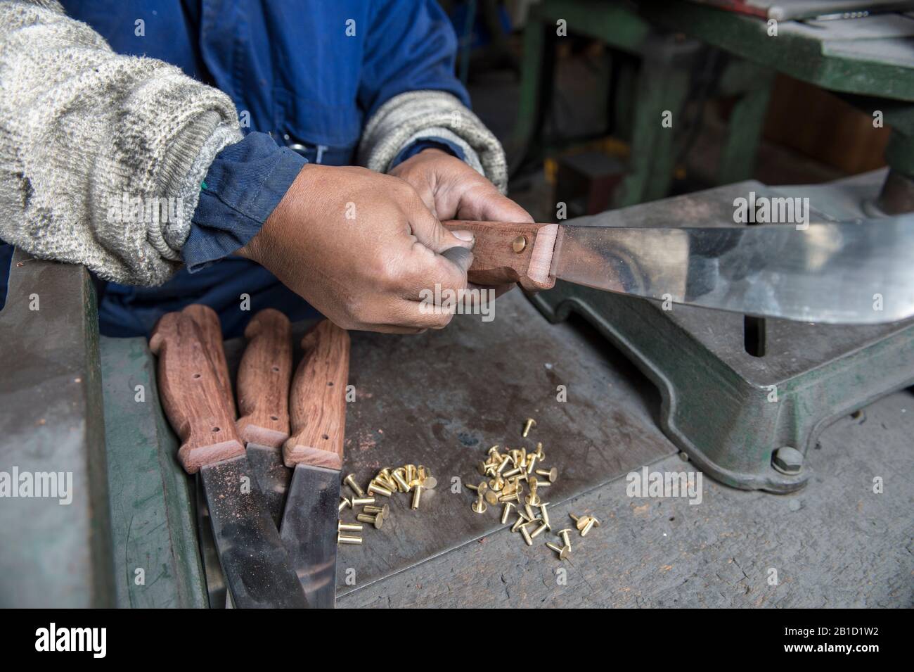 Riveting wooden handle to Butchers knife Stock Photo Alamy