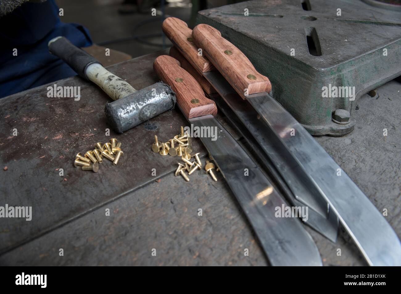 Riveting wooden handle to Butchers knife Stock Photo Alamy