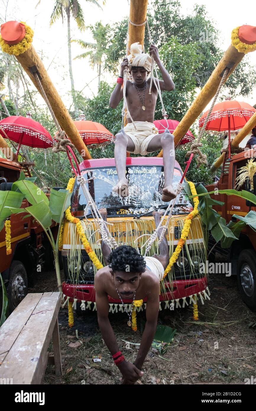 Devotees hanging by hooks piercing their skin as a ritualistic act of