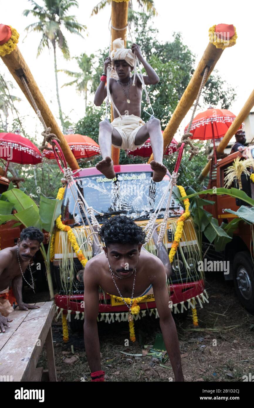 Devotees hanging by hooks piercing their skin as a ritualistic act of devotion, Garudan Thookkam (Eagle Hanging), during Thaipooyam, or Thaipoosam, Fe Stock Photo