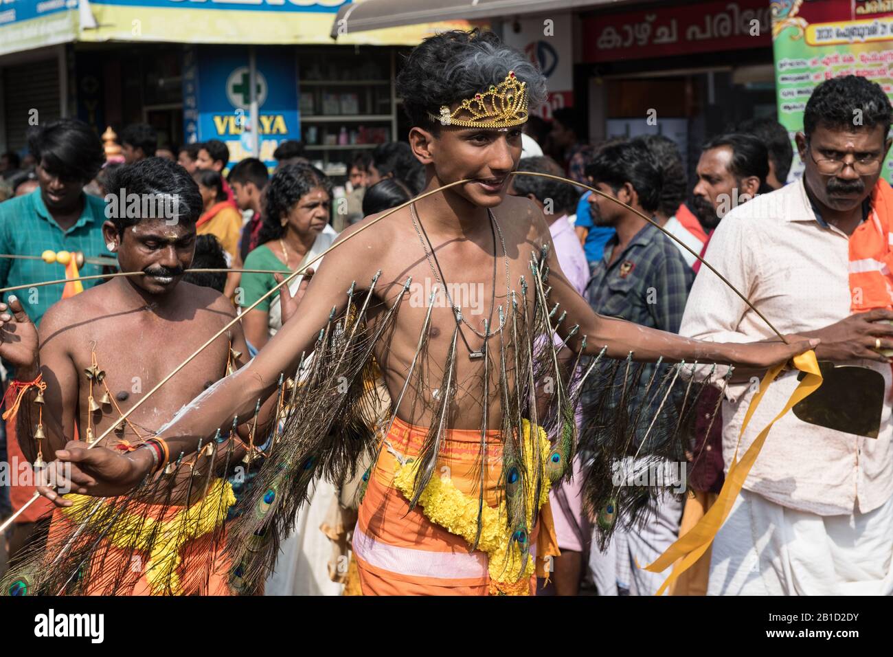 Devotees holding spears in their pierced mouths (Kavadi Aattam) as an act of devotion during Thaipooyam, or Thaipoosam, Festival in Kedakulam, Kerala. Stock Photo