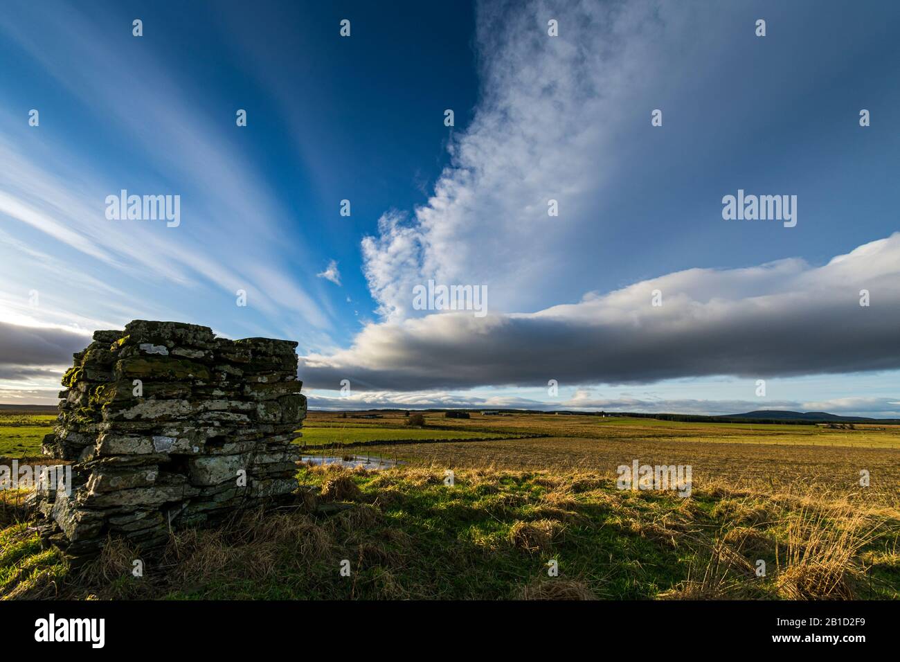 Dramatic sky above an old square cairn near Westerdale, Caithness, Scotland, UK Stock Photo