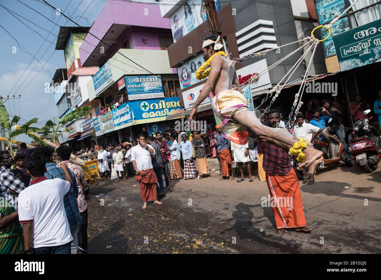 Devotee hanging by hook piercings as a ritualistic act of devotion