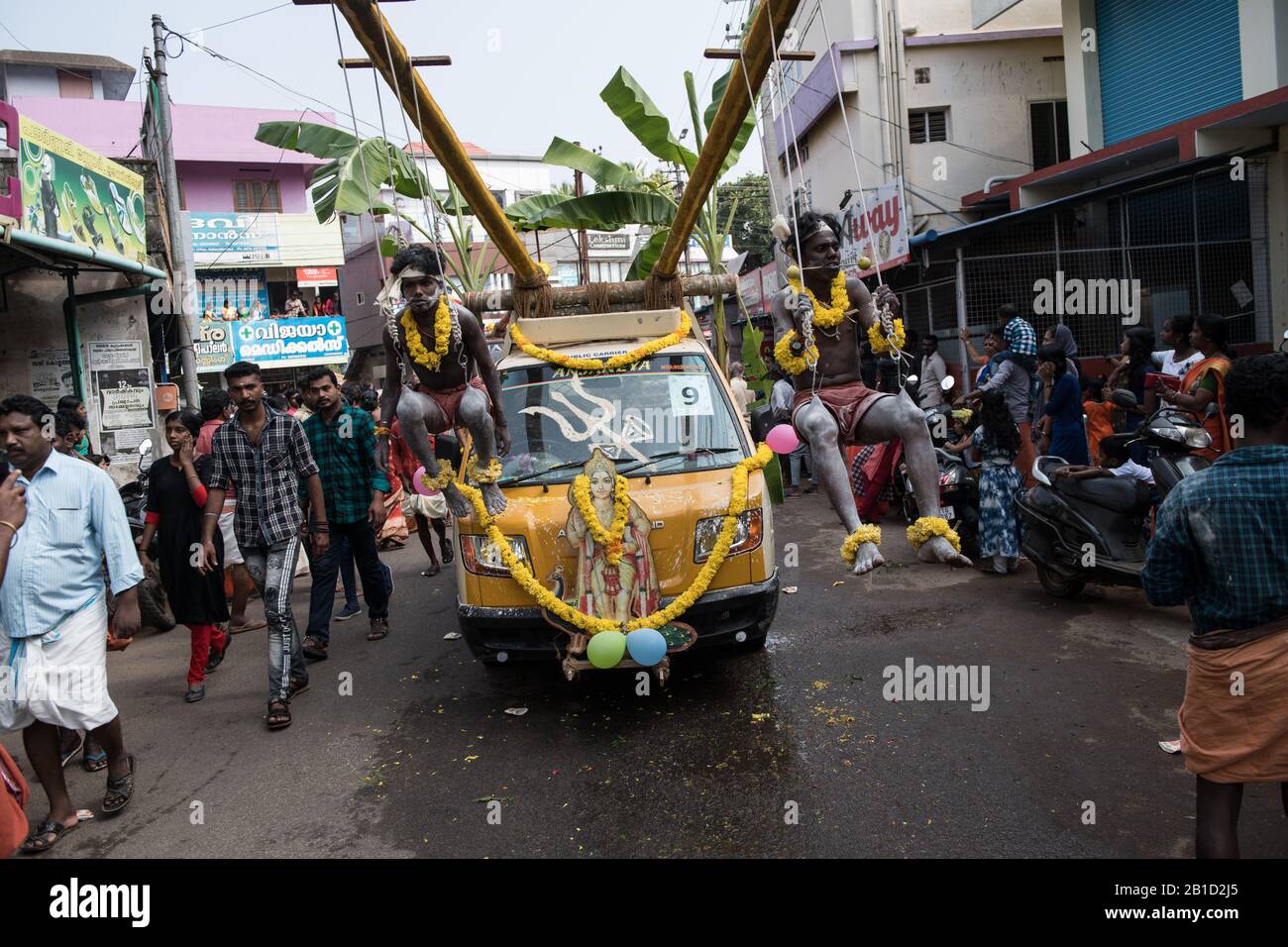 Devotees hanging by hooks piercing their skin as a ritualistic act of devotion, Garudan Thookkam (Eagle Hanging), during Thaipooyam, or Thaipoosam, Fe Stock Photo