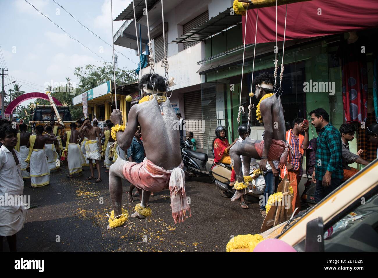 Devotees hanging by hooks piercing their skin as a ritualistic act of devotion, Garudan Thookkam (Eagle Hanging), during Thaipooyam, or Thaipoosam, Fe Stock Photo